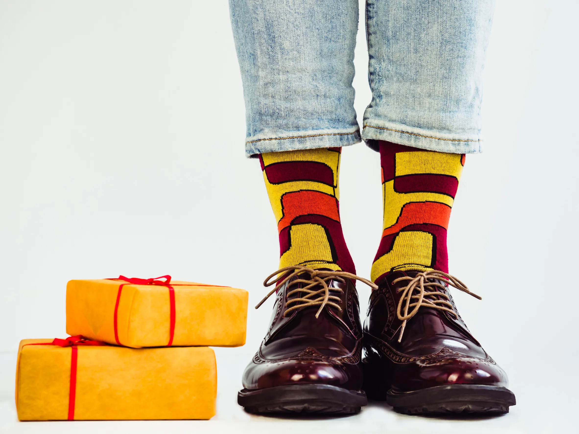 Man's feet with colorful socks and packages