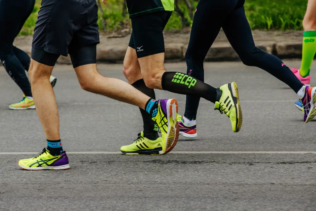 men running with different athletic socks